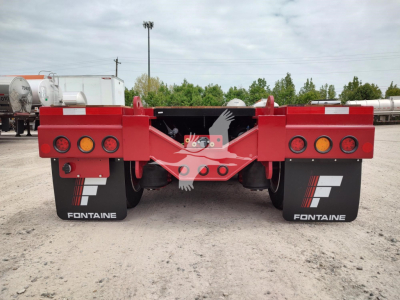 Fontaine paver pro trailer rear view showing red frame, dual axles, and brand mud flaps with Fontaine logo.