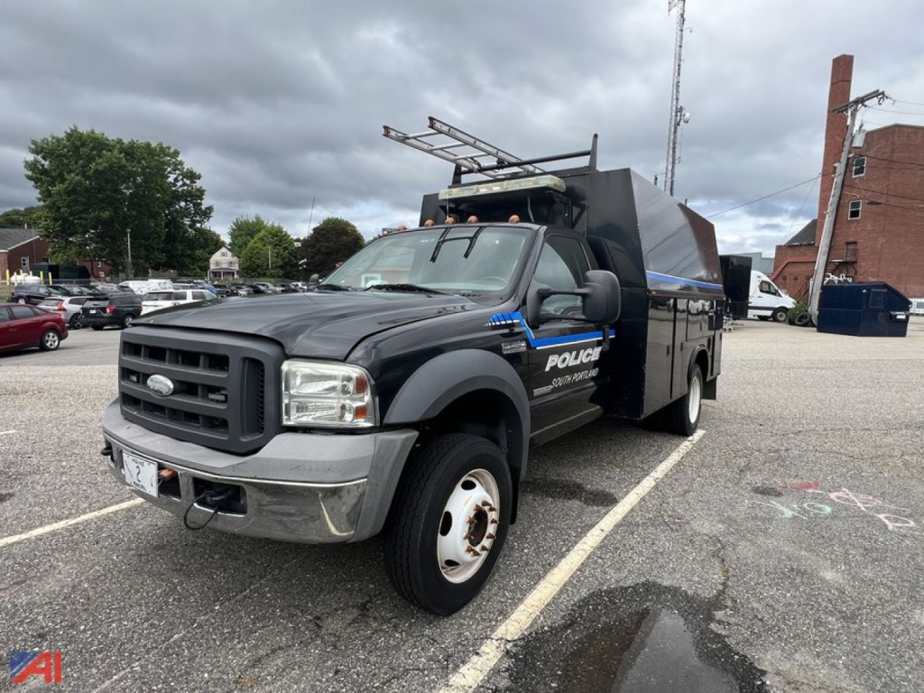Ford F-450 Super Duty utility truck in a parking lot with police markings on the side and a utility bed.