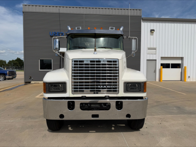 Front view of a white 2019 Mack PI64T conventional daycab truck showing large grille, bumper, headlights, and Mack emblem
