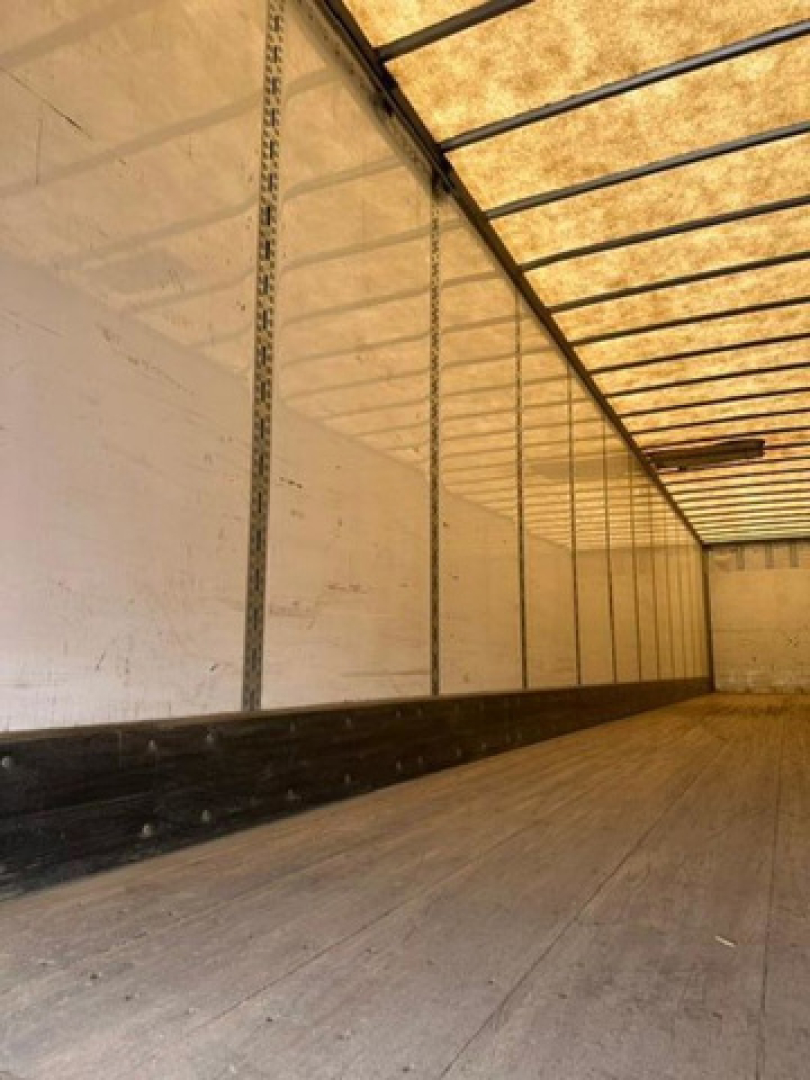 Interior view of a 2016 Wabash van trailer cargo area with aluminum sidewalls, vertical tracking, and wooden flooring.