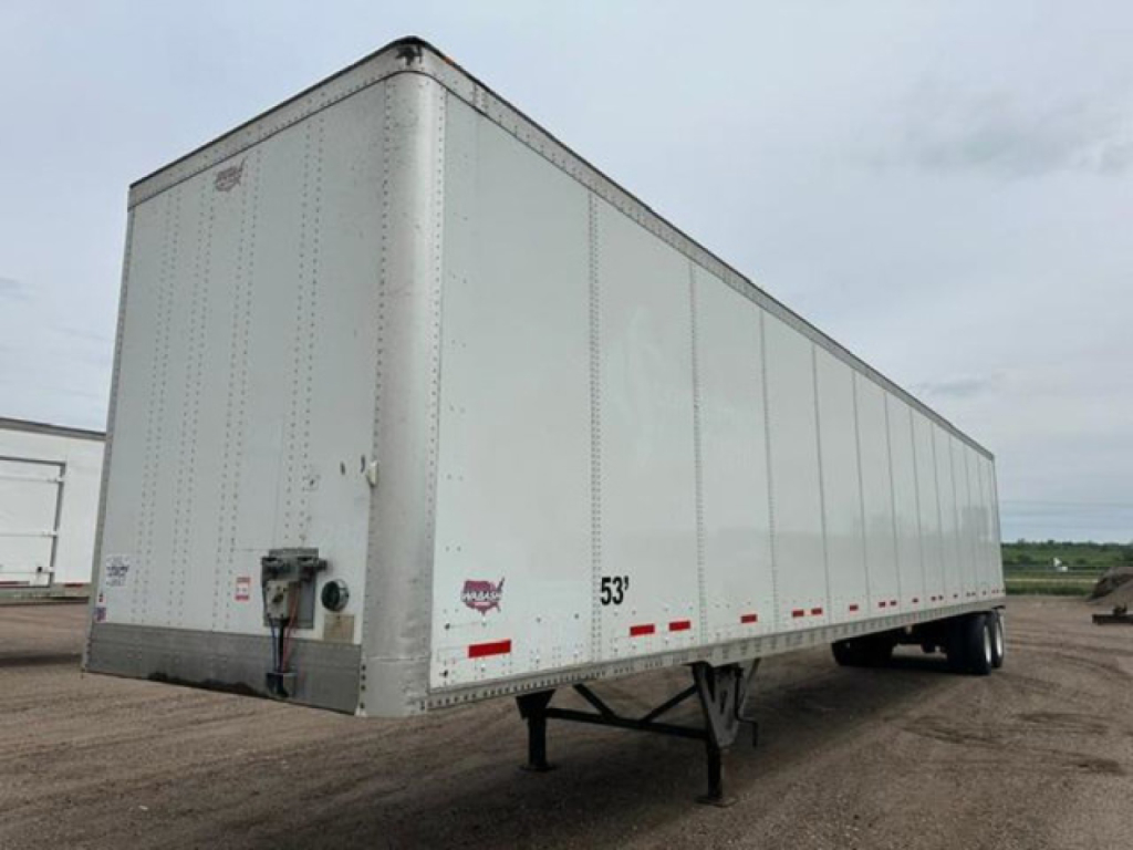  Trailer van showing a white 53' Wabash semi trailer with front nose, side doors, landing gear, and rear wheels visible.