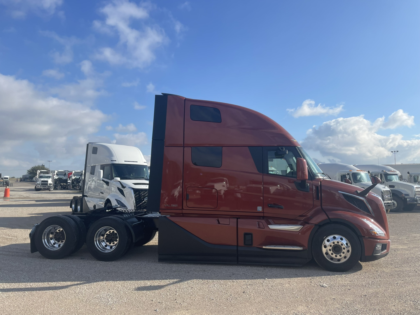 Volvo VNL64T860 tractor trailer in brown showing sleeper cab and side profile with dual rear axles.