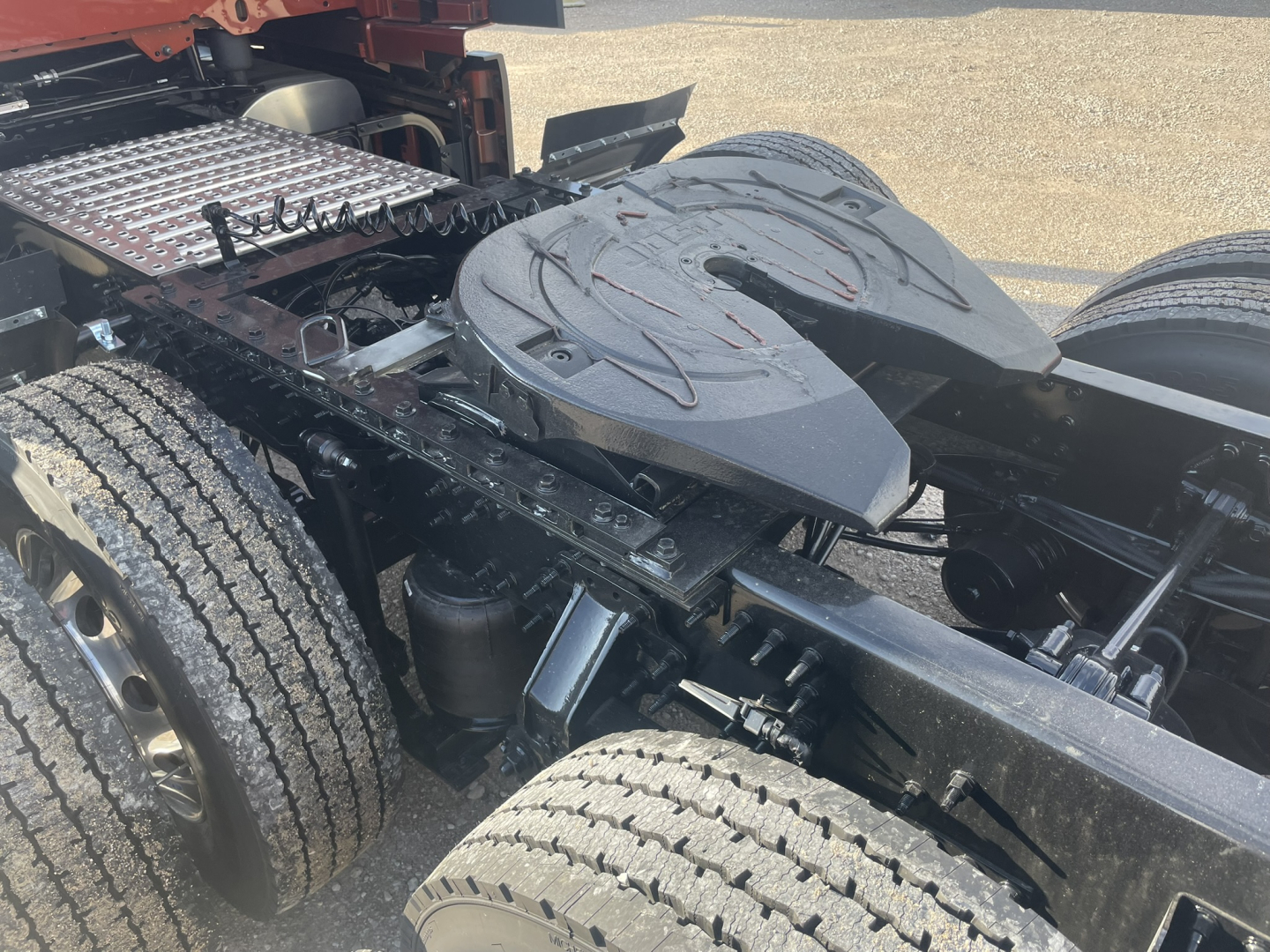 Volvo VNL64T860 truck chassis showing dual rear axles and sleeper cab area with plastic fender and deck plates.