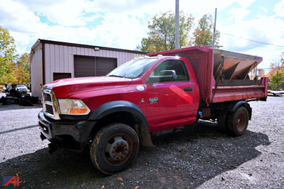 Dodge Ram 5500HD dump truck with red cab and dump bed, side view showing front grille and wheels.