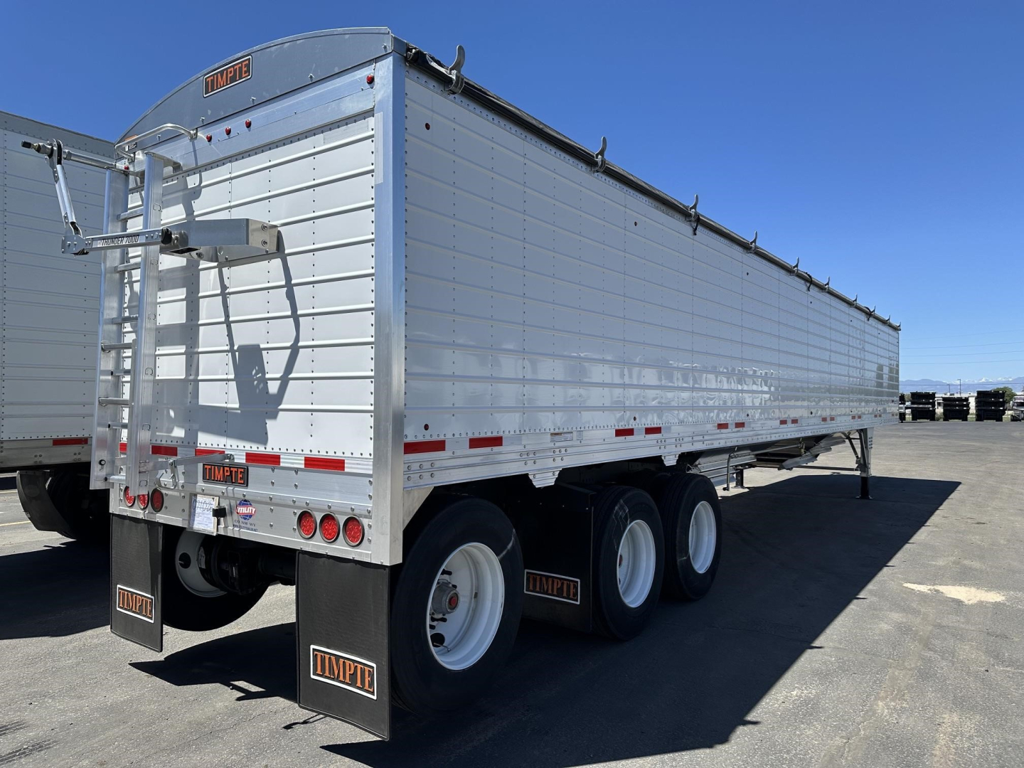 Timpte hopper trailer side and rear view showing 78" sides, tri-axle, aluminum siding, rear ladder, and mud flaps with Timpte logos.
