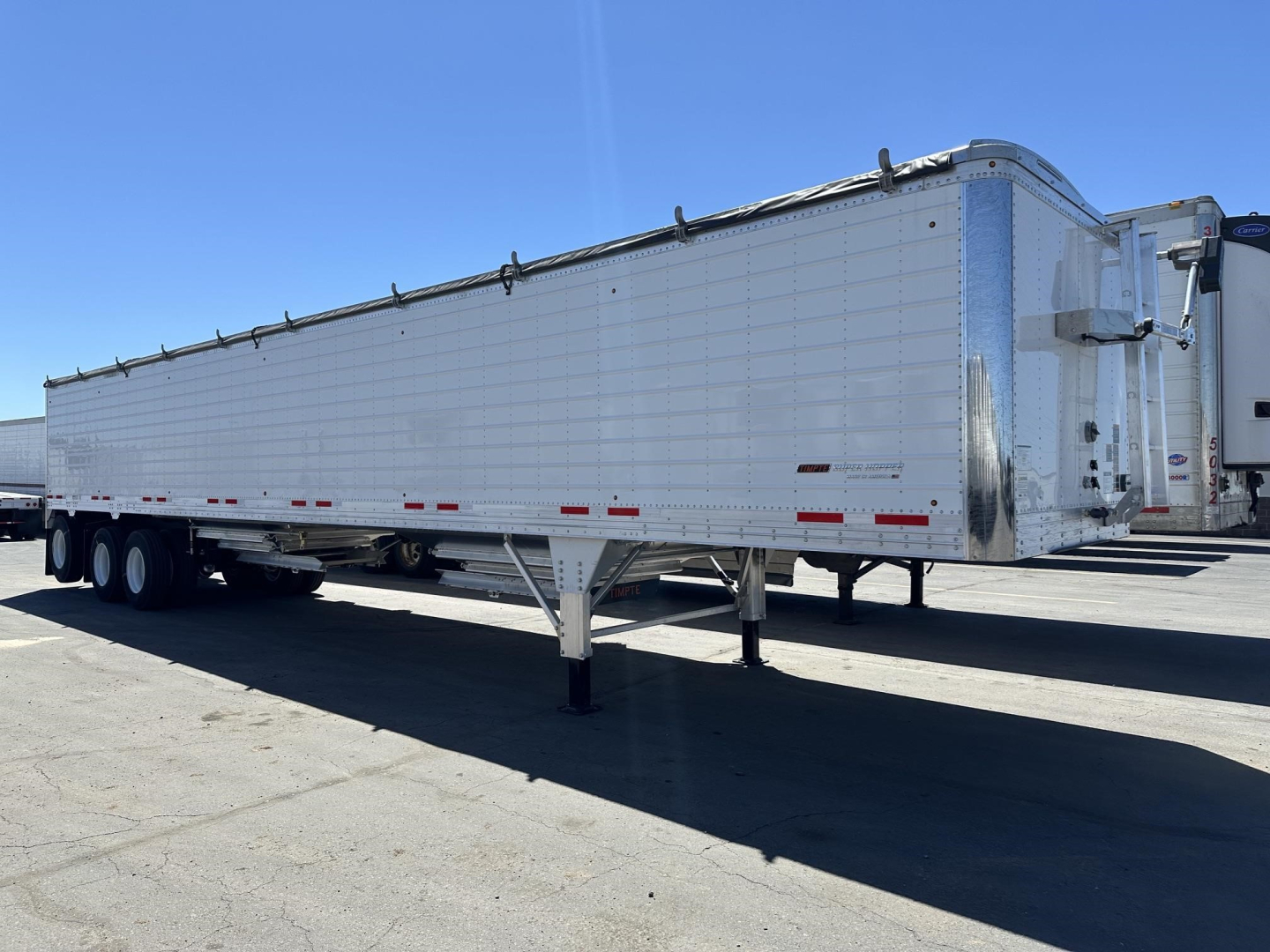 Timpte Super Hopper Tri Axle trailer with 78 inch side walls, side view showing aluminum hexagonal panels and front landing gear.