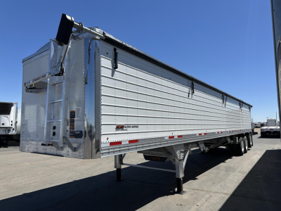 Tri axle Timpte hopper trailer with 78-inch high sides, aluminum body, rear ladder and landing gear visible.