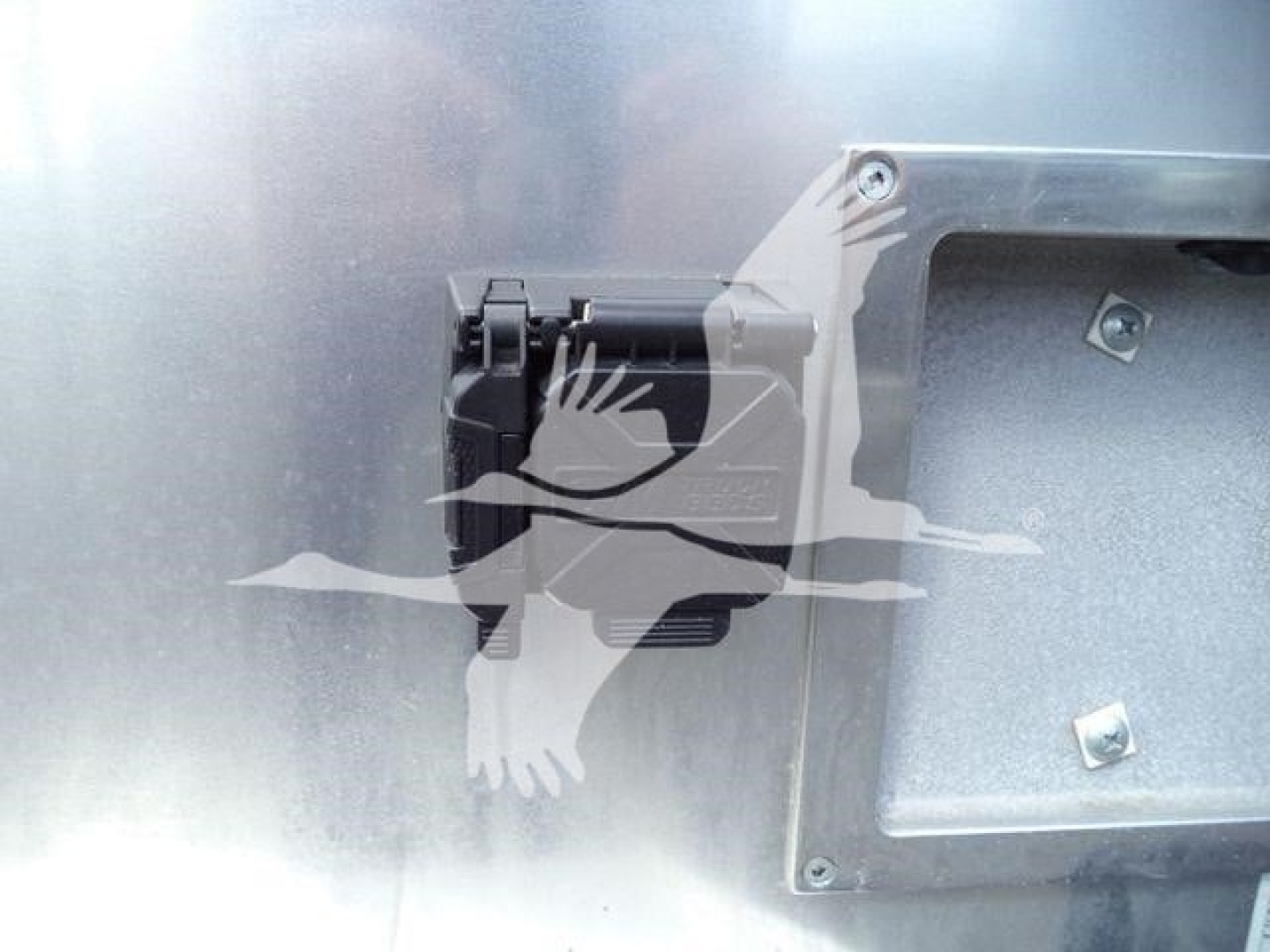 Ram 5500 engine bay component showing electrical connector and metal panel with bolts.