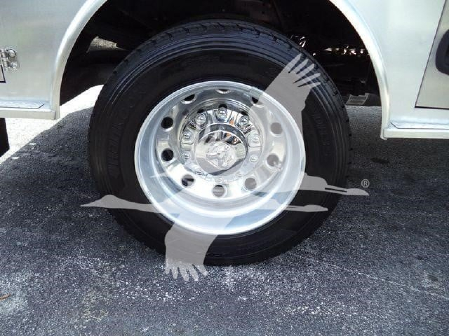 Ram 5500 wheel and tire close-up showing chrome hubcap and steel wheel with lug nuts.