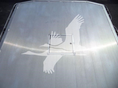 Truck hood with large bird graphic and central access hatch visible.