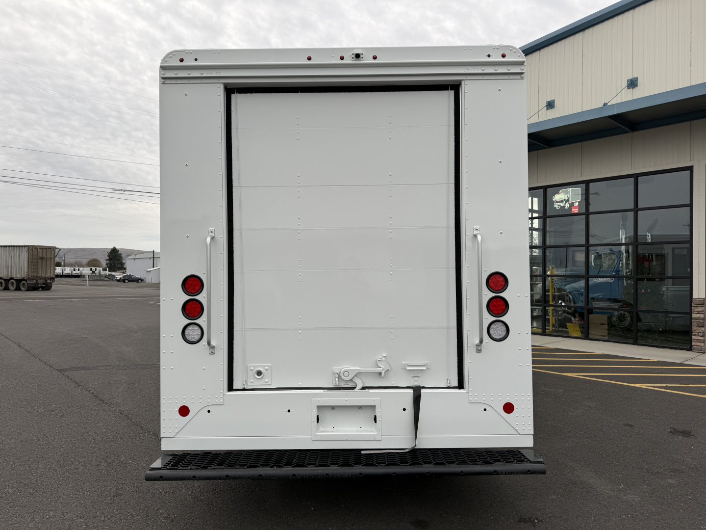 Harbinger S525 step van rear view showing large cargo doors, taillights, and bumper with hitch plate.
