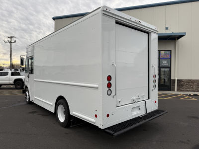 Harbinger S525 box truck rear view showing cargo doors and entry steps in white, side panel details, and wheel with black tire.