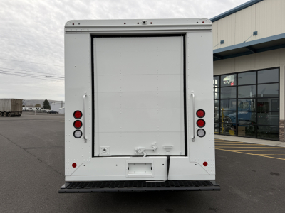 Harbinger S525 step van rear view showing large cargo doors, taillights, and bumper with hitch plate.