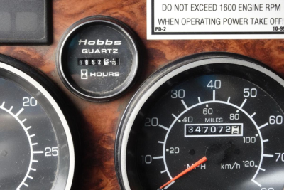 Dashboard gauges showing Hobbs hours gauge and odometer reading 3470729 miles. Surrounding gauges and a label reading 'DO NOT EXCEED 1600 ENGINE RPM WHEN OPERATING POWER TAKE OFF' partly visible.