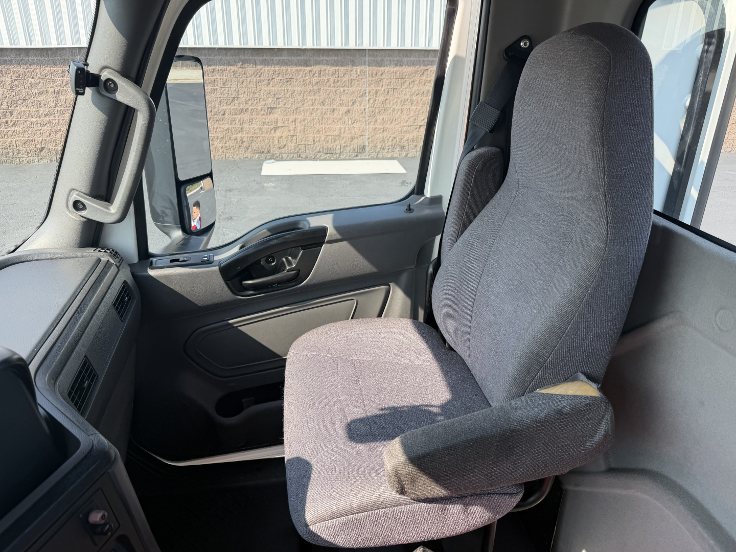 Interiors of a 2022 International LT625 daycab truck cabin showing driver seat and steering area.