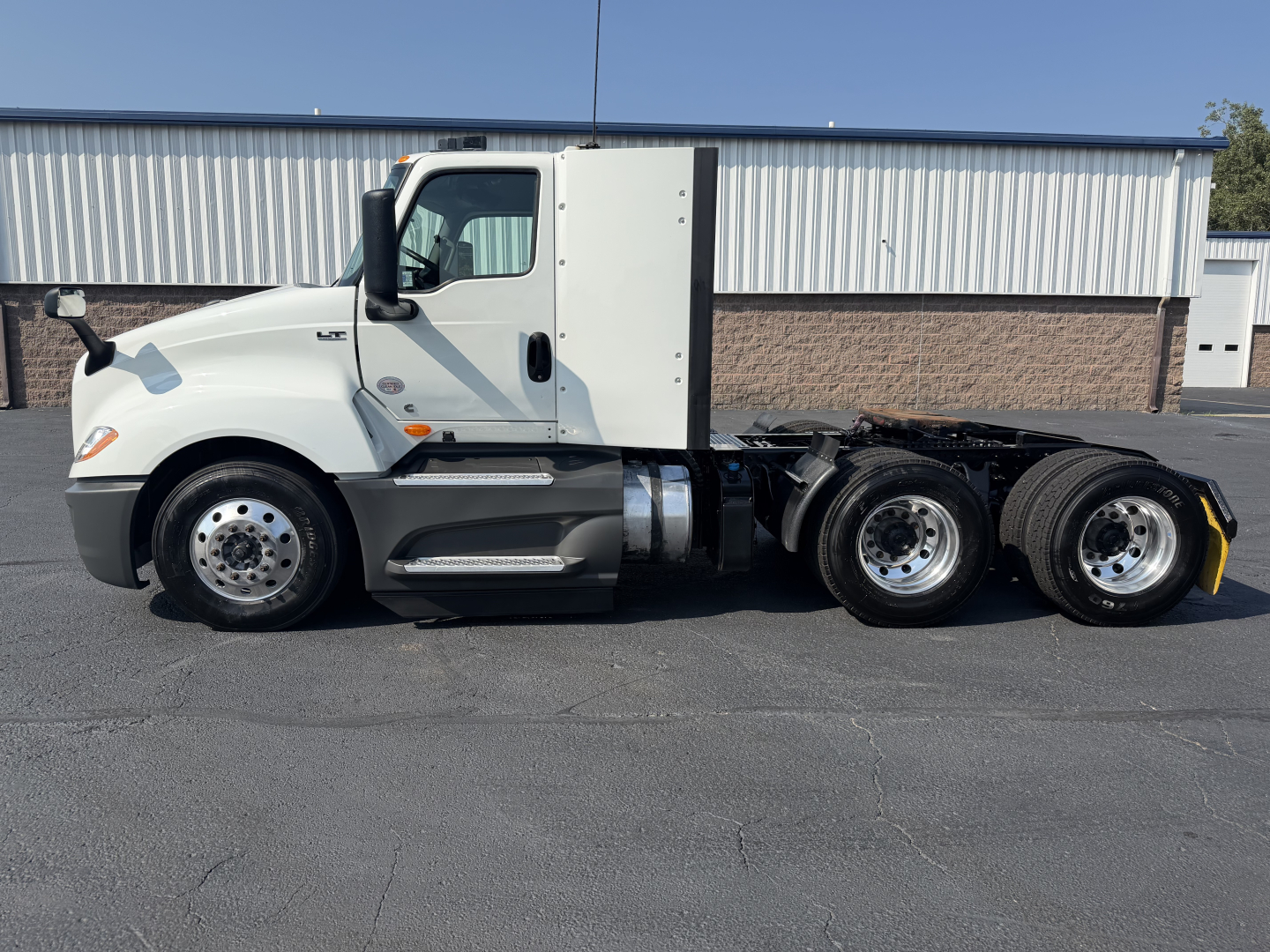 Truck side view showing 2022 International LT625 with sleeper cab and dual rear axles.