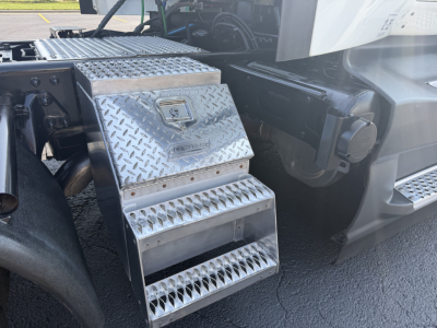 Conventional daycab truck side steps with diamond plate toolbox and steps, part of a 2022 International LT625.
