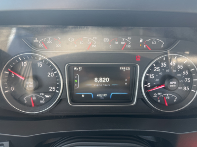 Dashboard of a 2022 International LT625 shows tachometer, speedometer, central digital display with engine hours 8,820, odometer 412,177, and gauge cluster; various warning lights illuminated.