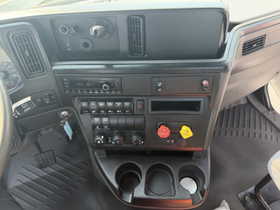 Dashboard interior of a 2022 International LT625 truck showing control panel, gauges, and cup holders.
