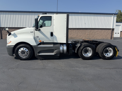 Truck side view showing 2022 International LT625 with sleeper cab and dual rear axles.