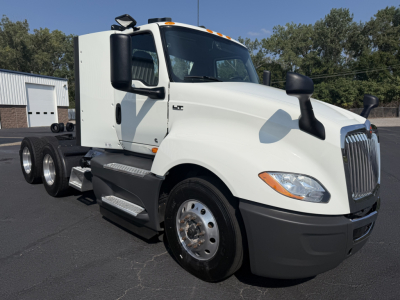 International LT625 truck cab and chassis in white, front-left view, with dual rear axles and chrome wheel covers.