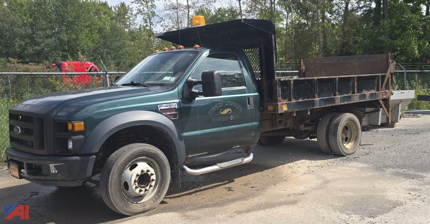 Ford F-450 XL Super Duty dump truck viewed from front-left side showing dump bed and dual rear wheels.