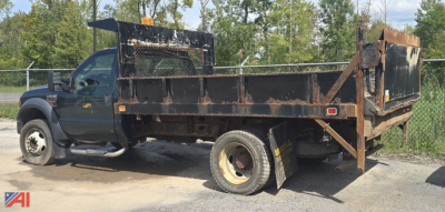 Ford F-450 XL Super Duty dump truck in-service showing metal dump bed with rust and a rear tailgate, VIN plate on side; side panels and wheel wells visible.