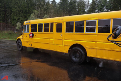 Yellow 2018 IC Corporation CE Series school bus side view with stop arm extended.