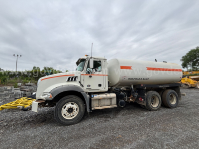 Mack Granite 64BR MHD fuel/oil tanker truck side view showing cylindrical tank and front cab.