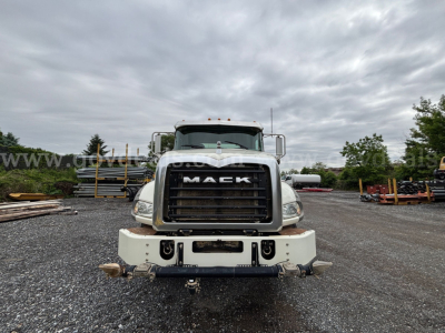 Front view of a 2020 Mack Granite 64BR MHD dump truck showing large black grille with 'MACK' emblem, white bumper, and headlights.