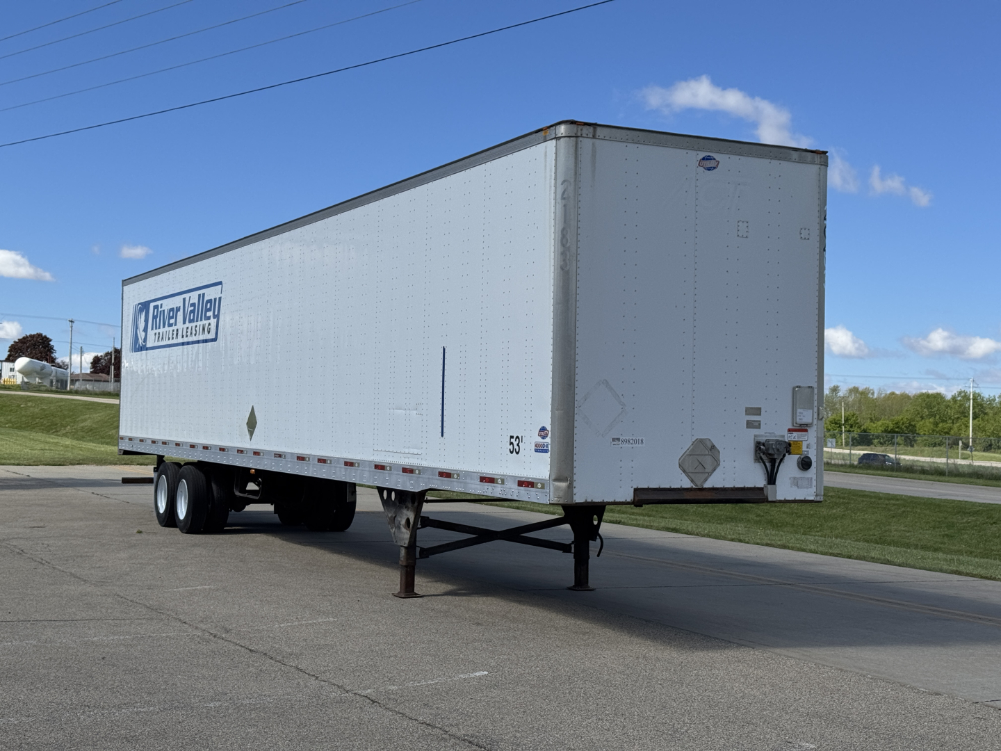Utility 4000D-X trailer unit showing River Valley trailer rental logo on side, front landing gear leg, dual rear wheels, and rearmost cargo doors.