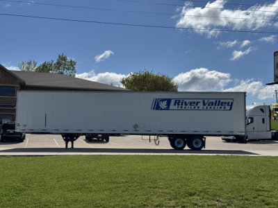Trailer with River Valley Trailers Leasing logo on white 53' trailer in a lot, side view showing dual rear axles and landing gear.