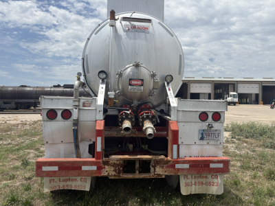 Back view of 2012 Dragon 150BBL vacuum trailer showing rear hoses and dual taillights with Diamond Dragon label on tank.
