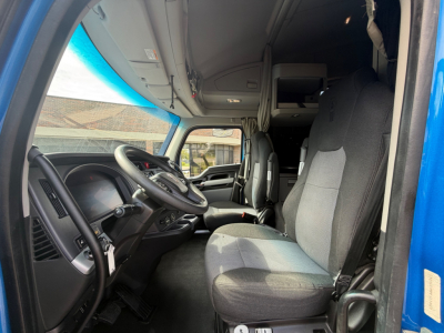 Kenworth T680 truck cab interior showing driver seat and dashboard with steering wheel and controls.