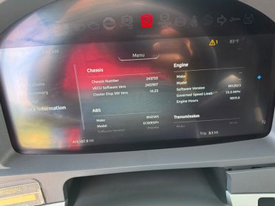 Dashboard display of a 2023 Kenworth T680 showing Chassis Number, Engine details, ABS, transmission, and trip data on the digital instrument cluster.
