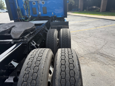 Kenworth T680 drivetrain area with dual rear axles and tires visible