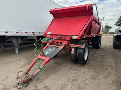 Trailer hitch and dump body showing red Ranco LW11-20P dump trailer with dual rear axles and green coiled air hose, attached to a gooseneck hitch.