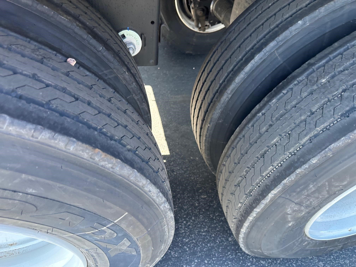 Timpte Roughneck trailer wheel area showing dual rear tires and part of axle; no visible text on tires or chassis.