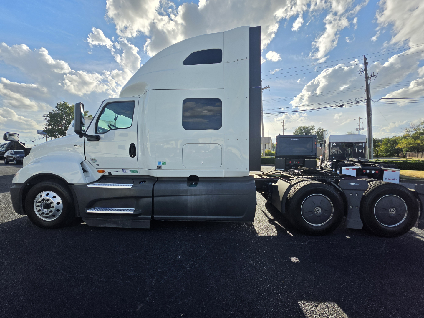 Truck side view showing 2023 International LT625 sleeper cab and chassis with white paint.