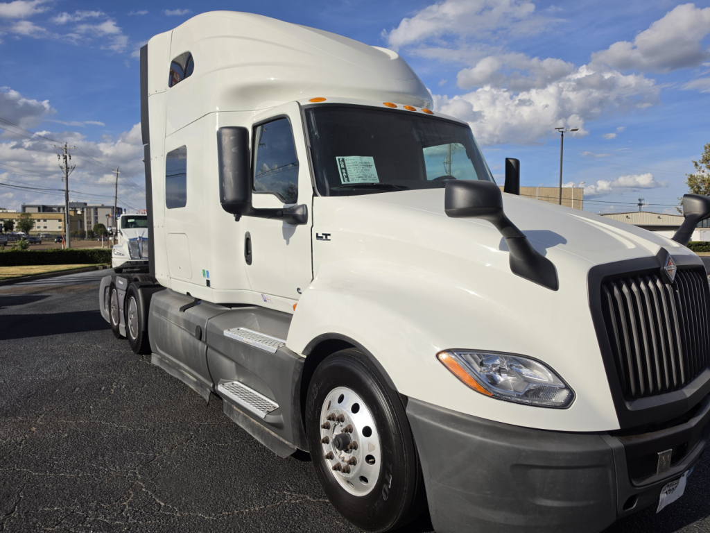 White 2023 International LT625 conventional sleeper truck front three-quarter view showing cab, windshield, headlights and side mirrors.