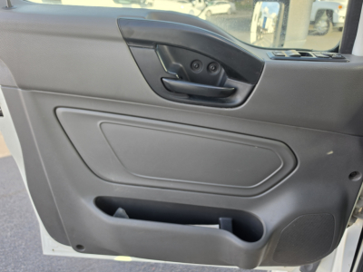 Truck interior door panel showing armrest with window/lock controls and storage pocket.