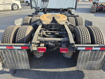 Tractor rear view showing fifth wheel, dual rear axles, and mud flaps on a used 2023 International LT625 truck chassis.