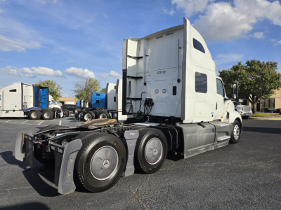 Truck: 2023 International LT625 sleeper tractor in a parking lot, side view showing rear wheels, fifth wheel, and cab with exhaust stacks; no visible damage.