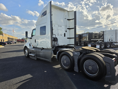 Truck sleeper cab showing International LT625 chassis and rear wheels.
