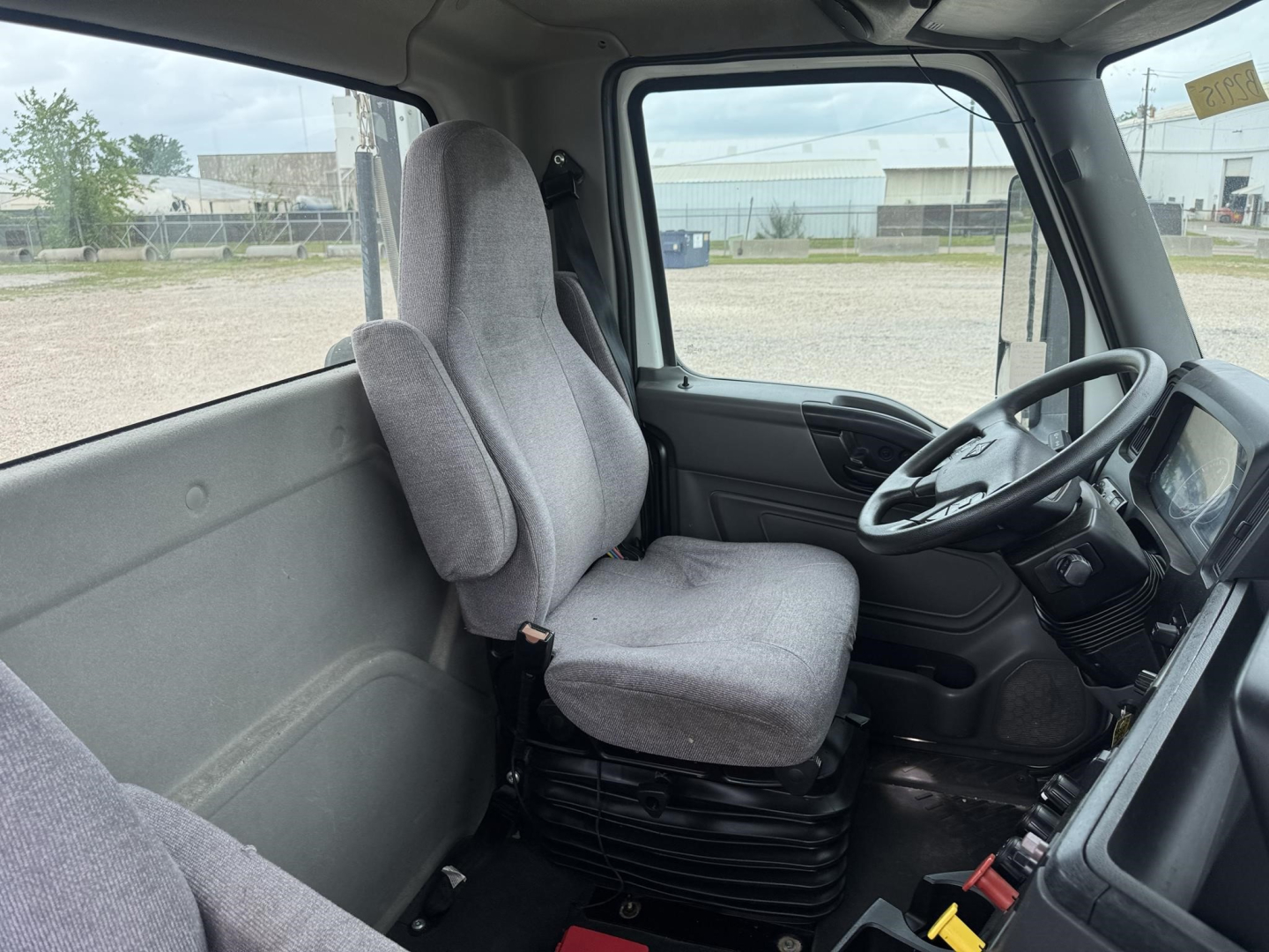 Interior view of a 2021 International LT cab showing driver seat and steering wheel.