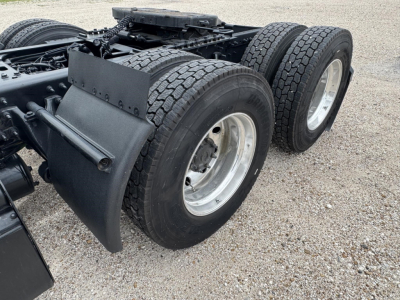 Truck rear dual-axle setup with heavy-duty mudflaps and twin rear wheels, chassis framing, and fifth wheel mounting area visible.