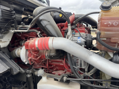 International LT engine bay showing turbocharger intake piping and coolant reservoir.