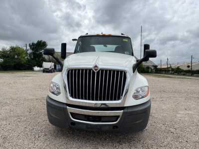 Front view of a white 2021 International LT conventional daycab truck with large vertical grille, black bumper, and side mirrors.