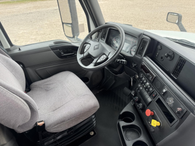 Cab interior of a 2021 International LT truck showing steering wheel, dashboard, and driver's seat.