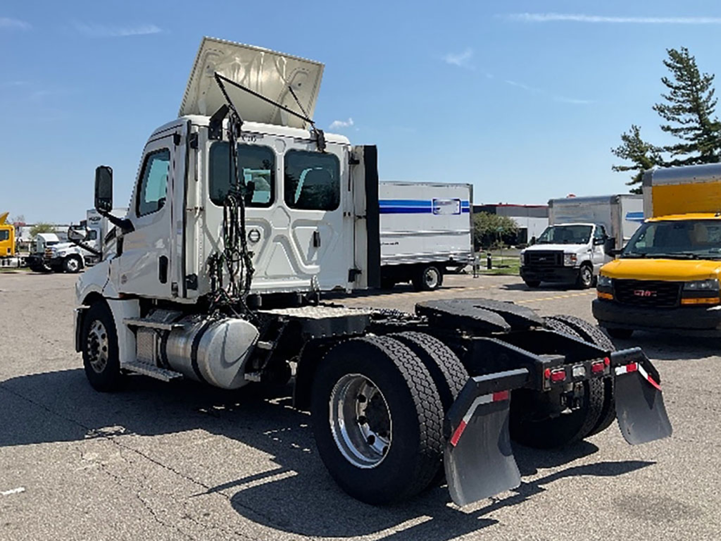 Truck cab chassis with sleeper cab, front and rear view showing Freightliner Cascadia 2019 designation; visible parts include dual rear axles, mud flaps, exhaust, cab, and raised hood; stock and VIN info not visible in text on image.